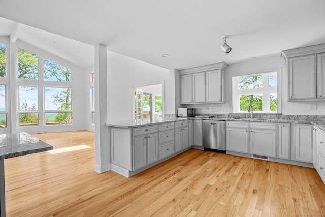 162 Shortwoods Rd, New Fairfield, CT 06812 - kitchen featuring appliances with stainless steel finishes, gray cabinetry, light wood-style flooring, backsplash, and light stone counters