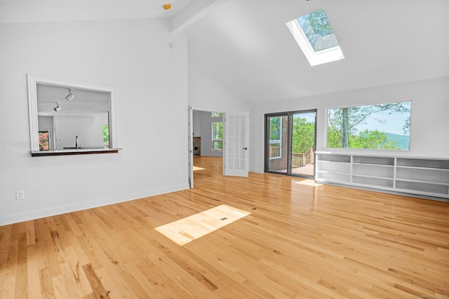 162 Shortwoods Rd, New Fairfield, CT 06812 - unfurnished living room featuring a skylight, high vaulted ceiling, beam ceiling, and wood finished floors