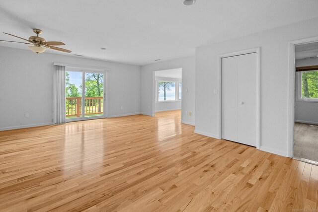162 Shortwoods Rd, New Fairfield, CT 06812 - unfurnished living room featuring healthy amount of natural light, light wood-style flooring, and ceiling fan
