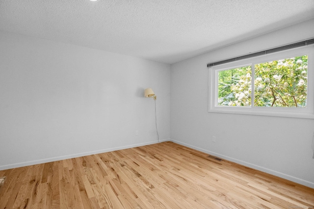 162 Shortwoods Rd, New Fairfield, CT 06812 - empty room with light wood finished floors and a textured ceiling