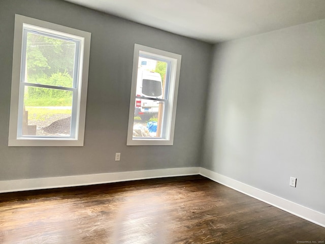 218 Charles St, Waterbury, CT 06708 - empty room with dark wood-style floors and baseboards