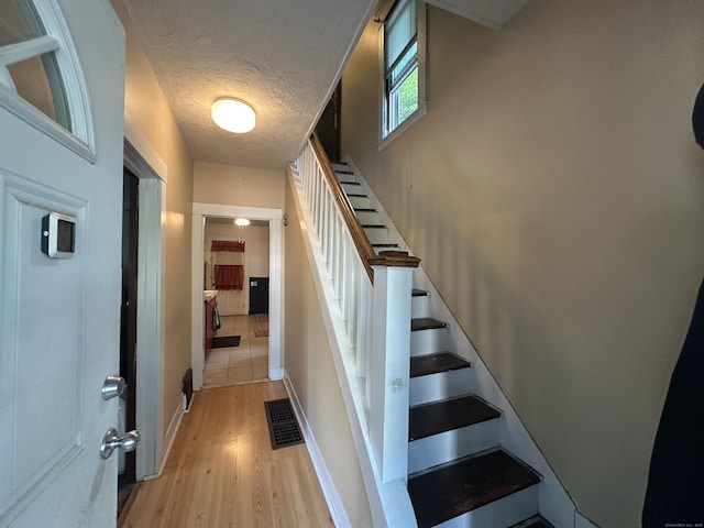 813 Russell St, New Haven, CT 06513 - staircase with wood finished floors and a textured ceiling
