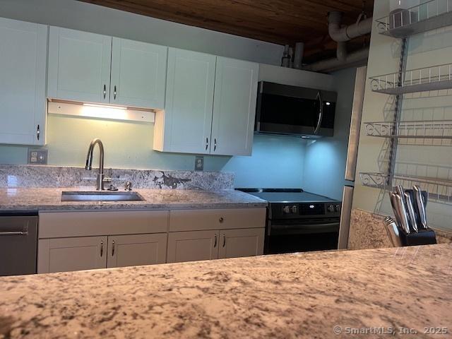 68 Thermos Ave Unit 206B, Norwich, CT 06360 - kitchen featuring appliances with stainless steel finishes, light stone countertops, and white cabinets