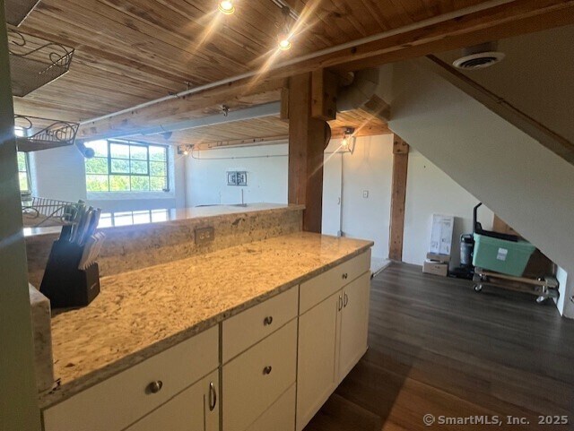 68 Thermos Ave Unit 206B, Norwich, CT 06360 - kitchen featuring white cabinetry, dark wood finished floors, wooden ceiling, and light stone counters