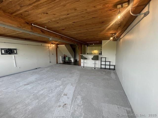 68 Thermos Ave Unit 206B, Norwich, CT 06360 - unfurnished living room featuring wooden ceiling, a garage, and unfinished concrete flooring