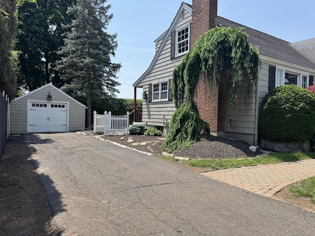 3 Fairview Hts, Cromwell, CT 06416 - view of home's exterior featuring an outdoor structure, a chimney, driveway, and a detached garage
