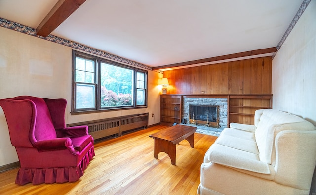 3 Fairview Hts, Cromwell, CT 06416 - living area with radiator heating unit, wood finished floors, beamed ceiling, and a fireplace