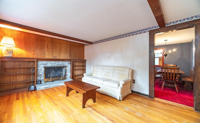 3 Fairview Hts, Cromwell, CT 06416 - living area with wood finished floors, a chandelier, a fireplace, beam ceiling, and wood walls