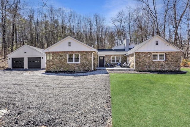 45 Westledge Rd, Simsbury, CT 06092 - view of front of home featuring stone siding, an outdoor structure, a detached garage, and a chimney