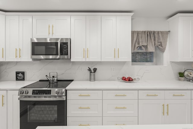 45 Westledge Rd, Simsbury, CT 06092 - kitchen with stainless steel appliances, white cabinets, and decorative backsplash