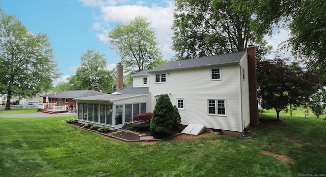 154 Sandy Ln, Meriden, CT 06450 - back of house with a chimney, a sunroom, and a yard