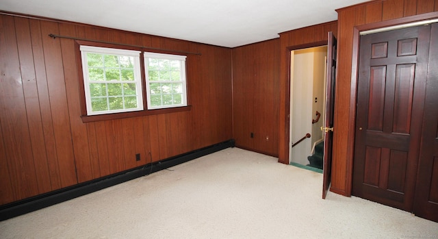 154 Sandy Ln, Meriden, CT 06450 - unfurnished bedroom featuring baseboard heating, light colored carpet, and wooden walls