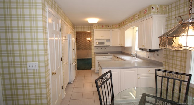 154 Sandy Ln, Meriden, CT 06450 - kitchen with white appliances, light tile patterned floors, wallpapered walls, white cabinetry, and a peninsula