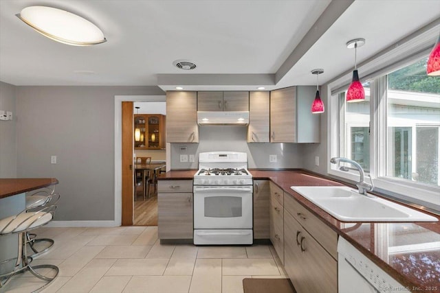 60 Ranch Rd, Milford, CT 06460 - kitchen with white appliances, under cabinet range hood, dark countertops, decorative light fixtures, and light tile patterned floors