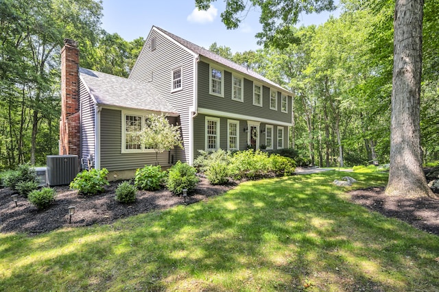 31 Country Way, Madison, CT 06443 - view of front facade featuring a chimney, a front yard, and a shingled roof
