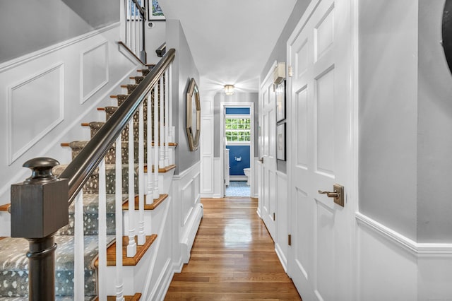 31 Country Way, Madison, CT 06443 - corridor with a decorative wall, wood finished floors, stairs, and wainscoting