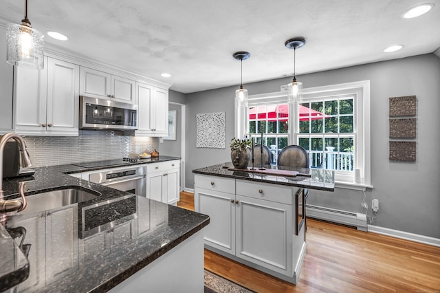 31 Country Way, Madison, CT 06443 - kitchen with stainless steel appliances, a baseboard heating unit, decorative backsplash, white cabinets, and recessed lighting
