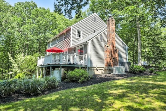 31 Country Way, Madison, CT 06443 - back of house featuring a deck, a chimney, and a lawn