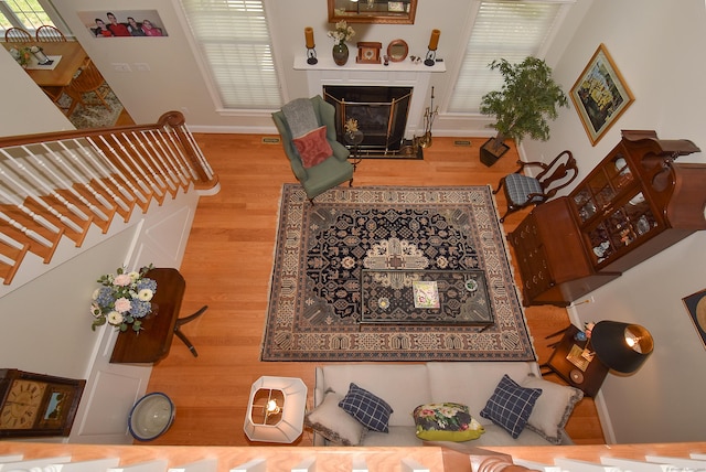 16 Brookfield Dr, Ellington, CT 06029 - living area with wood finished floors, stairway, and a fireplace