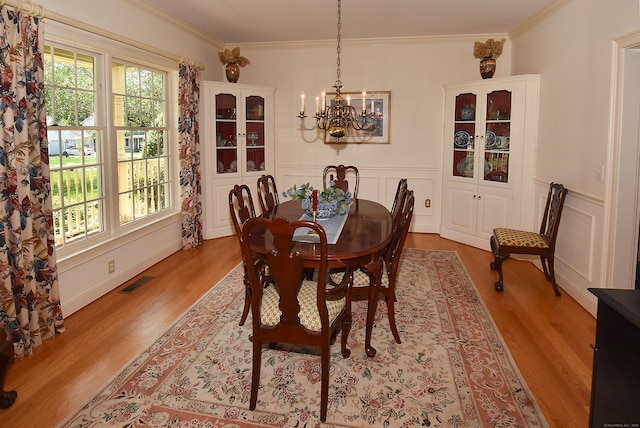 16 Brookfield Dr, Ellington, CT 06029 - dining space featuring a chandelier, wood finished floors, crown molding, wainscoting, and a decorative wall