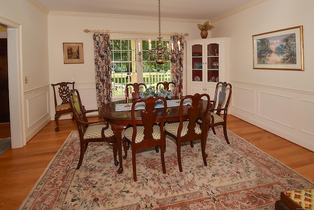 16 Brookfield Dr, Ellington, CT 06029 - dining room featuring crown molding, light wood-style flooring, a chandelier, a decorative wall, and wainscoting