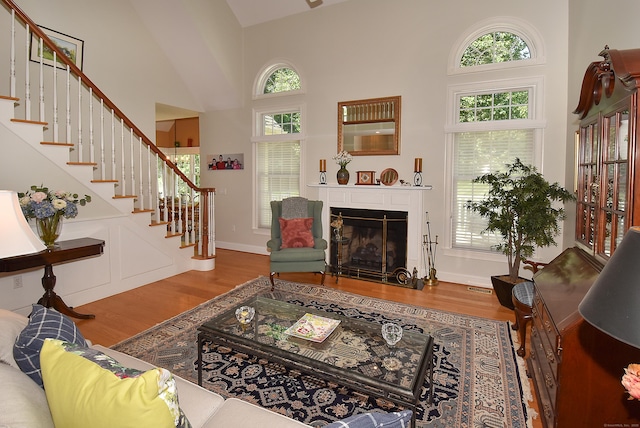 16 Brookfield Dr, Ellington, CT 06029 - living area with high vaulted ceiling, wood finished floors, stairway, and healthy amount of natural light