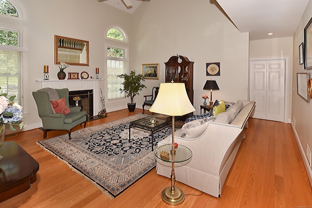 16 Brookfield Dr, Ellington, CT 06029 - living room featuring a ceiling fan, wood finished floors, a fireplace with flush hearth, and a towering ceiling