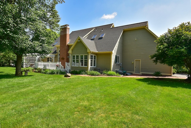 16 Brookfield Dr, Ellington, CT 06029 - rear view of house with a lawn, a chimney, roof with shingles, and a deck