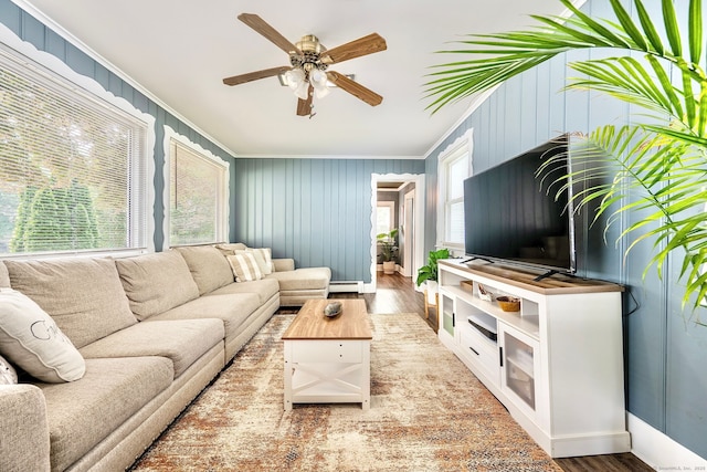64 Mohawk Ave, Derby, CT 06418 - living area featuring crown molding, wood finished floors, a ceiling fan, wooden walls, and a baseboard heating unit