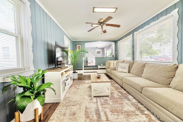 64 Mohawk Ave, Derby, CT 06418 - living room with ornamental molding, wood finished floors, a baseboard heating unit, a ceiling fan, and arched walkways