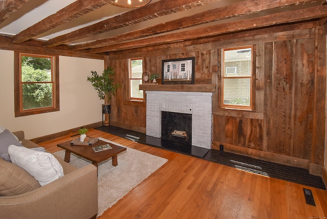 20 Battle St, Somers, CT 06071 - living area with a brick fireplace, wooden walls, wood finished floors, and plenty of natural light
