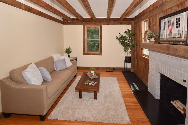 20 Battle St, Somers, CT 06071 - living room featuring beam ceiling, light wood-style floors, and a brick fireplace
