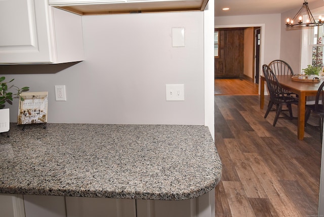 20 Battle St, Somers, CT 06071 - kitchen with a chandelier, white cabinets, dark wood finished floors, stone counters, and hanging light fixtures