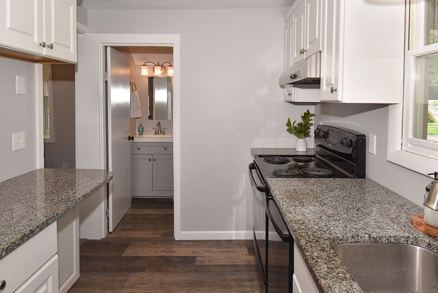 20 Battle St, Somers, CT 06071 - kitchen featuring black electric range, dark wood-style flooring, under cabinet range hood, white cabinetry, and dark stone counters