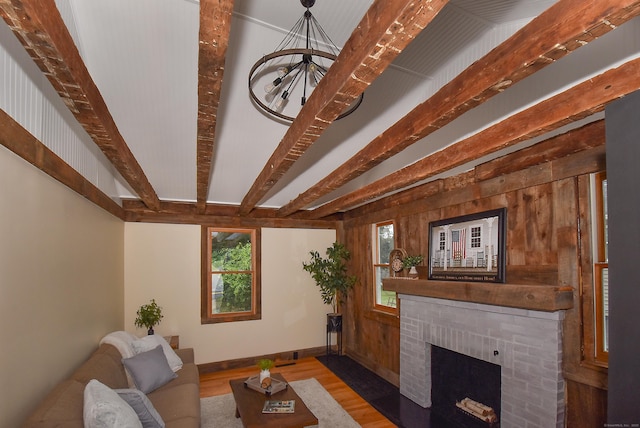 20 Battle St, Somers, CT 06071 - living area featuring wood finished floors, beam ceiling, a fireplace, and a chandelier