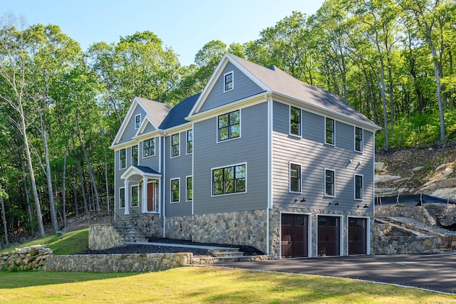 19 Ives Ct, Ridgefield, CT 06877 - view of front of property featuring a garage, a front yard, and driveway