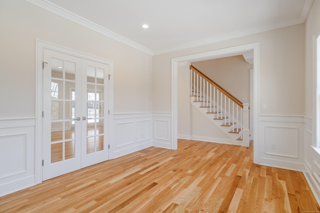 19 Ives Ct, Ridgefield, CT 06877 - spare room featuring french doors, a decorative wall, light wood-type flooring, crown molding, and stairs