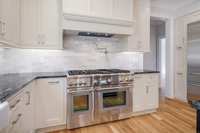 19 Ives Ct, Ridgefield, CT 06877 - kitchen with premium appliances, white cabinetry, custom range hood, light wood-type flooring, and ornamental molding