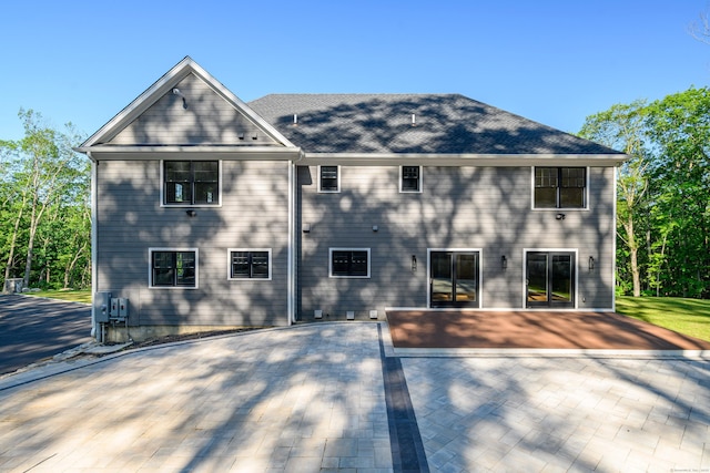 19 Ives Ct, Ridgefield, CT 06877 - rear view of house featuring a patio area and a shingled roof