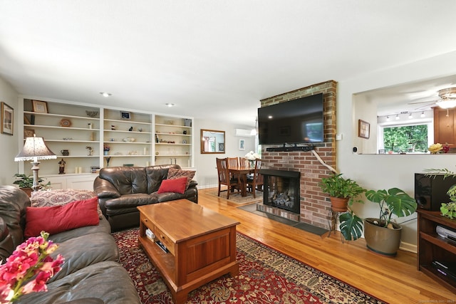 247 Mountain View Rd, Somers, CT 06071 - living area with wood finished floors, ceiling fan, and a brick fireplace
