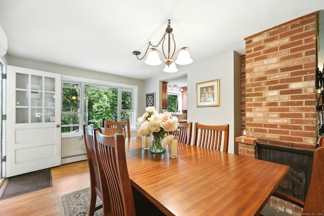 247 Mountain View Rd, Somers, CT 06071 - dining space with a baseboard heating unit, a chandelier, and light wood-type flooring
