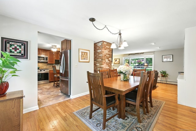 247 Mountain View Rd, Somers, CT 06071 - dining area with a baseboard heating unit, light wood finished floors, and a chandelier