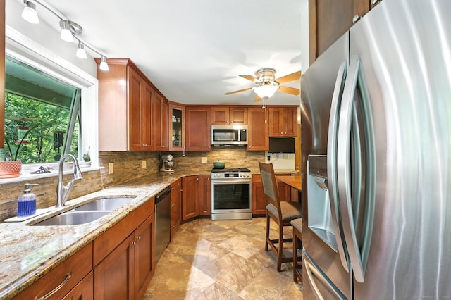 247 Mountain View Rd, Somers, CT 06071 - kitchen with stainless steel appliances, brown cabinetry, tasteful backsplash, and light stone counters