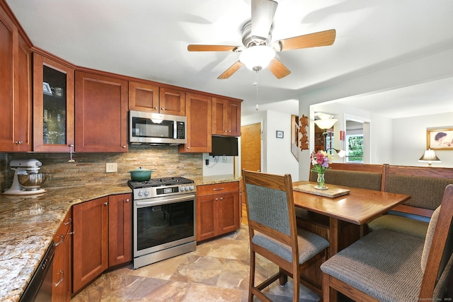 247 Mountain View Rd, Somers, CT 06071 - kitchen featuring stainless steel appliances, decorative backsplash, a ceiling fan, glass insert cabinets, and light stone counters