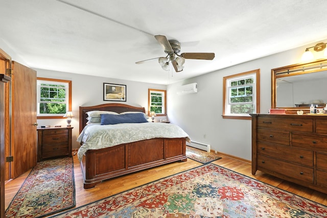 247 Mountain View Rd, Somers, CT 06071 - bedroom with a wall mounted air conditioner, a baseboard radiator, light wood-style flooring, and a ceiling fan