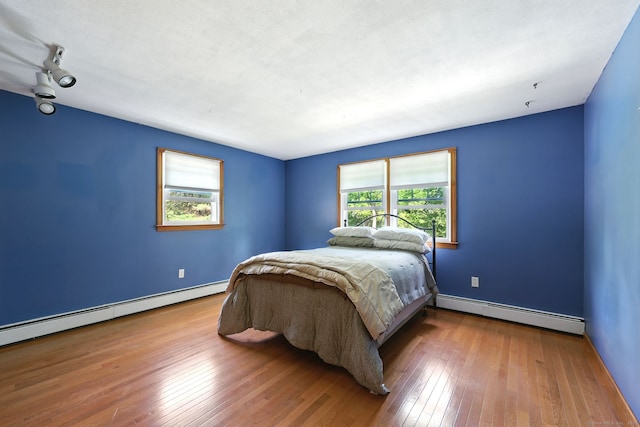 247 Mountain View Rd, Somers, CT 06071 - bedroom with baseboard heating, multiple windows, and hardwood / wood-style flooring