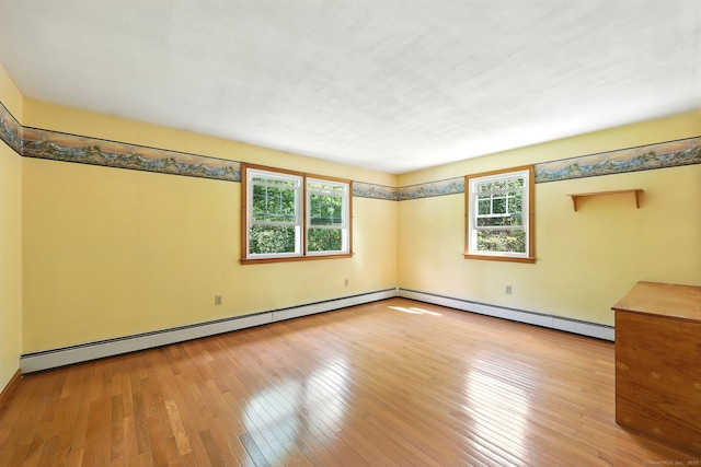 247 Mountain View Rd, Somers, CT 06071 - empty room with a baseboard heating unit, plenty of natural light, and hardwood / wood-style flooring