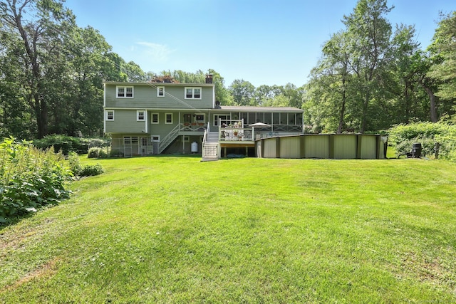 247 Mountain View Rd, Somers, CT 06071 - rear view of property with stairway, a sunroom, a chimney, and a lawn