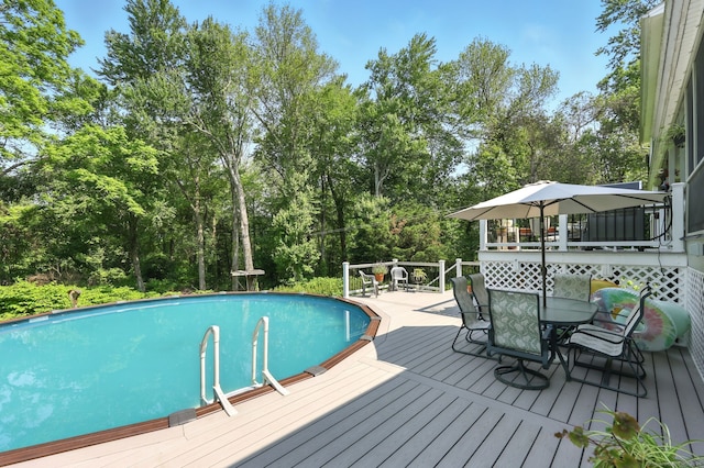 247 Mountain View Rd, Somers, CT 06071 - swimming pool with outdoor dining space, a wooden deck, and view of wooded area