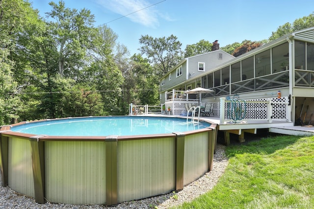 247 Mountain View Rd, Somers, CT 06071 - swimming pool with a sunroom, a deck, and view of wooded area